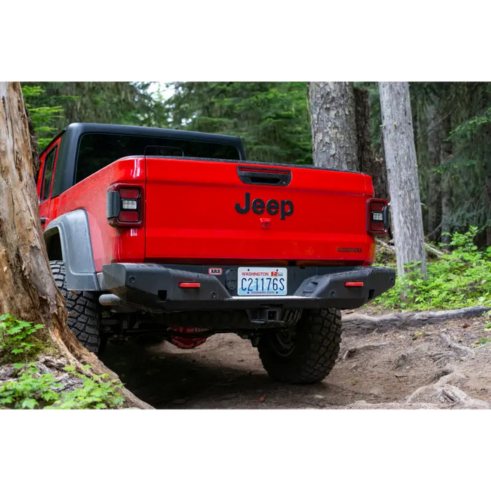 Red Jeep parked in wooded area near tree - ARB 20-21 Jeep Gladiator JT Rear Bumper.