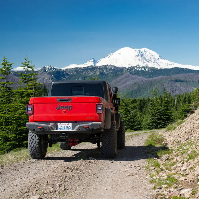 Red Jeep Gladiator JT rear bumper on rocky road.