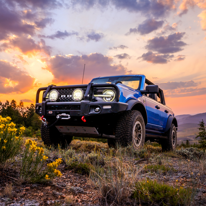 2021 ford bronco summit bumper with blue jeep wrangler on rocky road