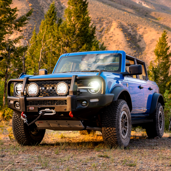 2021 ford bronco summit winch bumper parked truck in front of mountain with trees