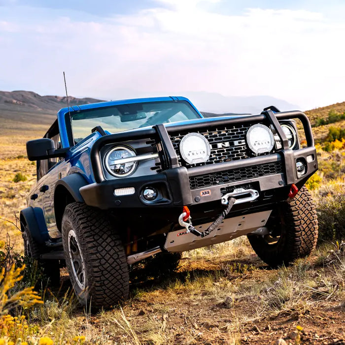 ARB 2021 Ford Bronco under vehicle protection with blue jeep in field