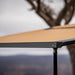 Close up of Arb Aluminum Awning table with tree in background