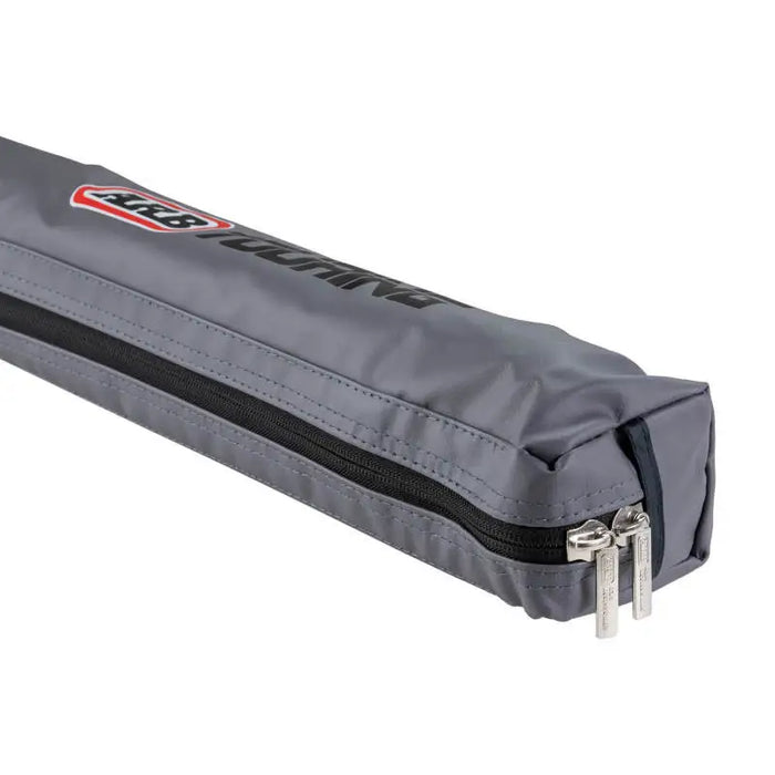 Grey zippered bag with red and black logo for ARB awning kit with light installed