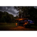 Arb awning kit with light installed, truck parked in woods at night