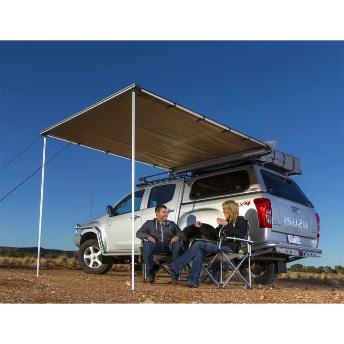 Man sitting in truck under arb awning kit tent