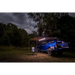 ARB awning light LED strip on blue van parked in woods at night.