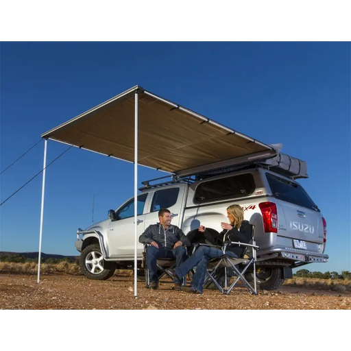 Man sitting under tent in ARB Awning w/Light 6.5ft x 8.2ft on Jeep Wrangler