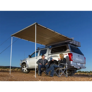 Man sitting in truck under tent featured in ARB Awning w/Light 6.5x8.2ft product.