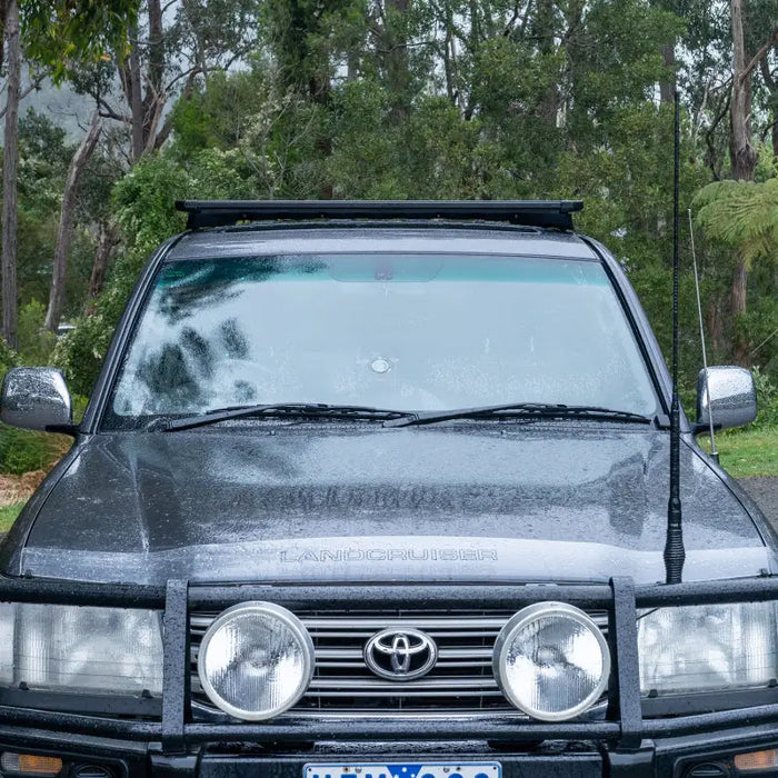 Black car parked in the rain, displayed with arb base rack mount kit for base rack 1770030.