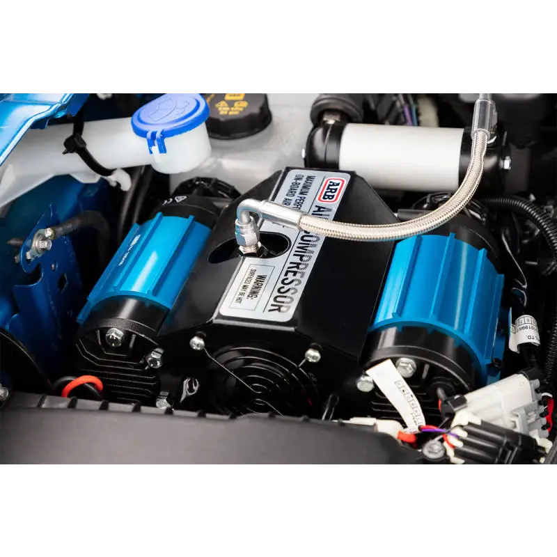 ARB Compressor Twin 12V with blue car engine and white/black cover