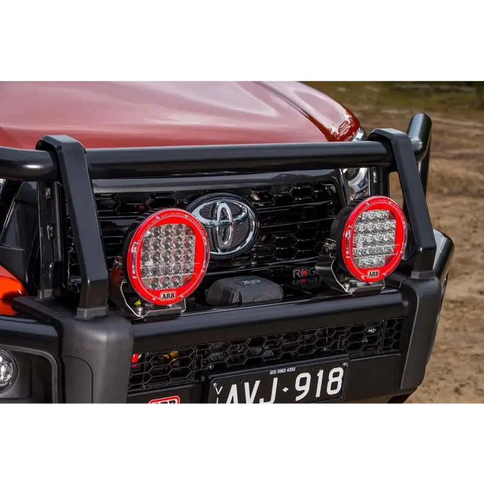 Clear ARB Cover for Jeep Wrangler front bumper light on red truck