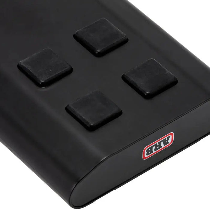 Black electronic device with four buttons: ARB Fridge Power Pack for use with ARB Zero Fridge Freezers.