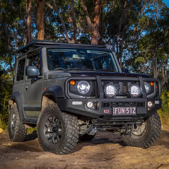 ARB Intensity Solis 21 LED lights mounted on a jeep parked on a dirt road.