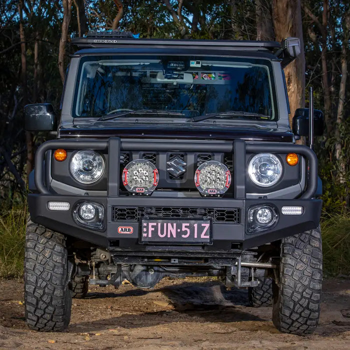 Front end of black Suzuki Jimny with light bar - ARB Intensity SOLIS 21 Spot Flood Kit