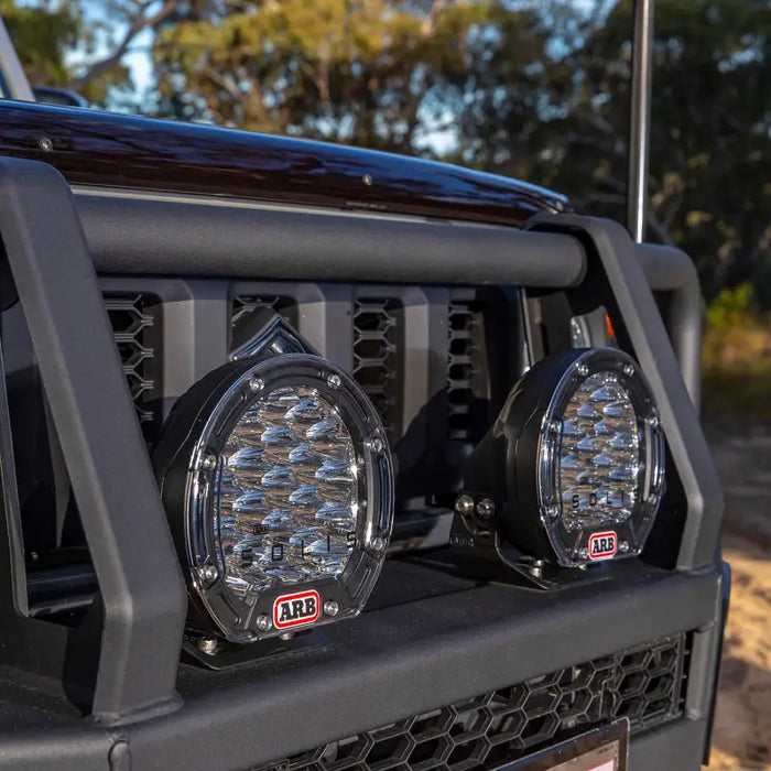 Close up of ARB Intensity Solis 21 2 Flood Kit with front lights on jeep