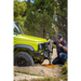 Man using power tool to remove tire with ARB Jack Base - 15400lbs Load Capacity.