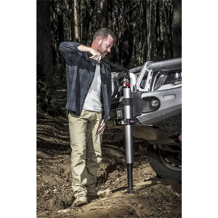 Man stands next to hydraulic technology ARB Jack truck.