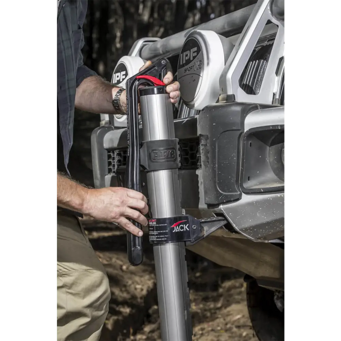 Man using hydraulic technology farm jack ARB Jack to fix vehicle.