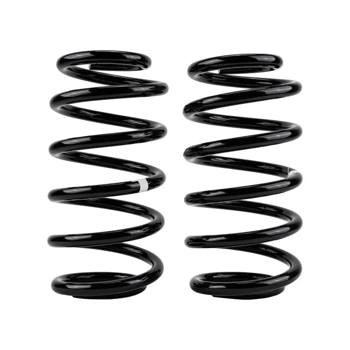 Pair of black OME coil springs on white background, for ARB rear Jeep Cherokee.