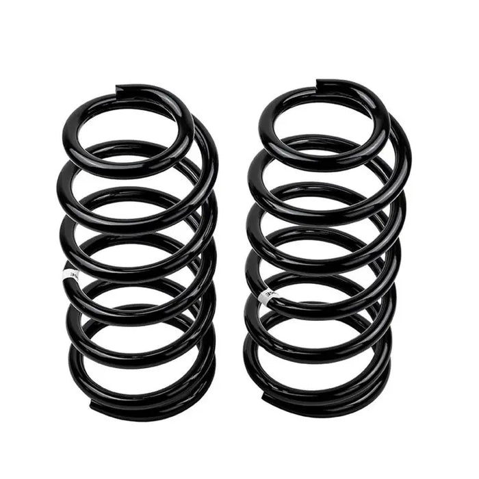 Pair of black OME coil springs on white background