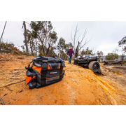 ARB premium recovery kit S2 featuring black and orange ATV with man standing next to it