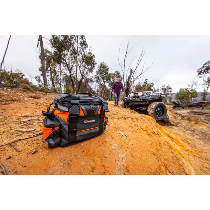 ARB premium recovery kit S2 featuring black and orange ATV with man standing next to it