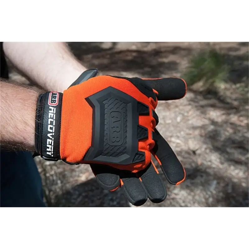 Man wearing orange ARB Recovery Glove with black and white lettering.