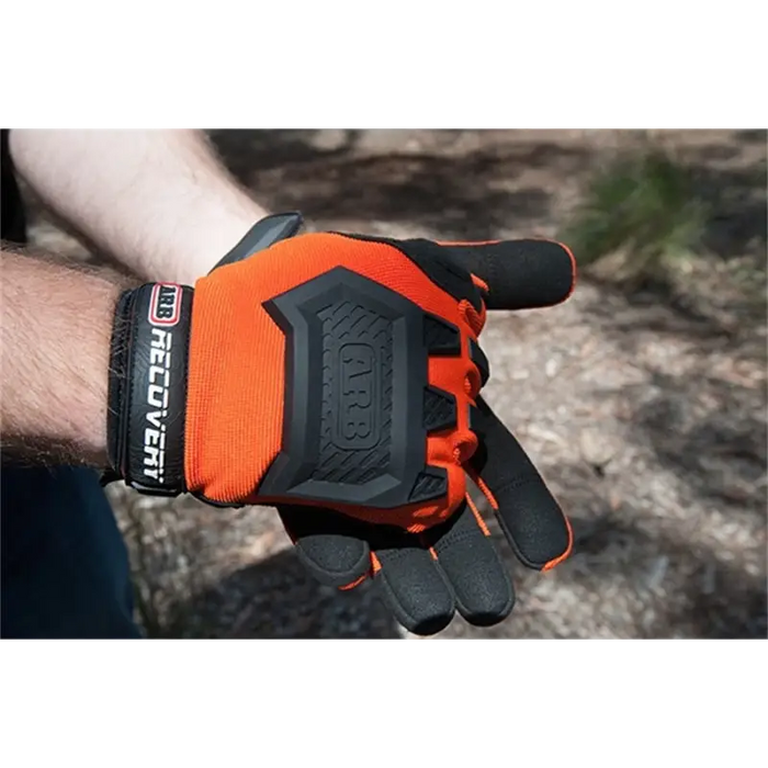 Man wearing orange ARB Recovery Glove with black and white lettering.