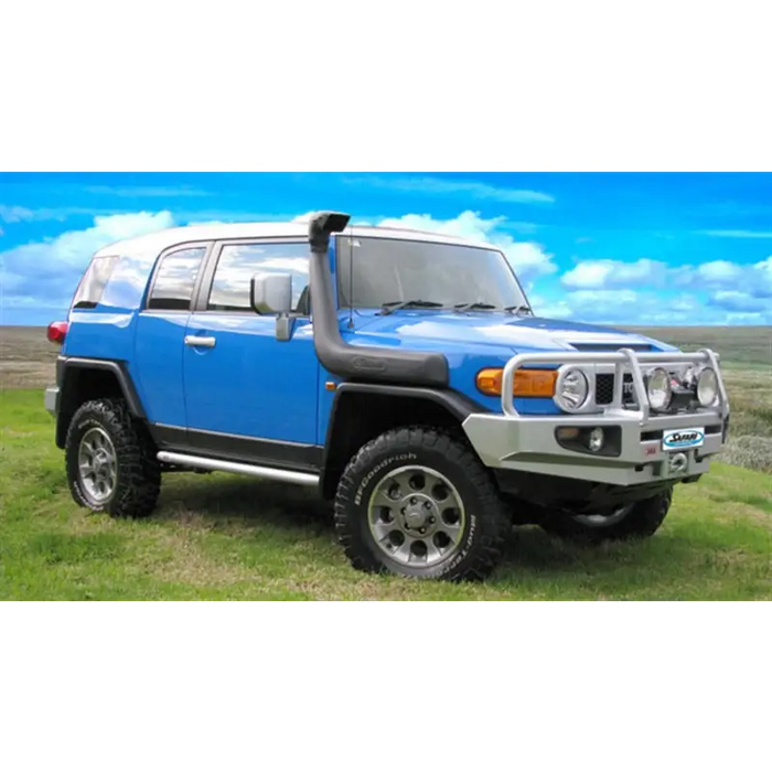 Blue Toyota FJ Cruiser parked in a field with ARB Safari 4X4 Snorkel Vspec.