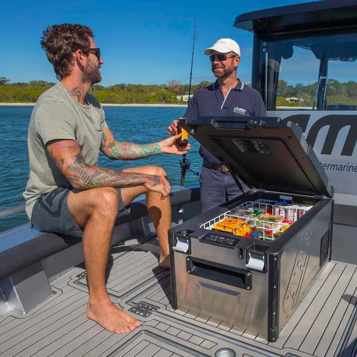 Two men on a boat with a cooler by ARB 63 Quart Fridge.