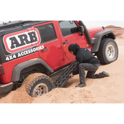 Man pouring sand into red jeep tire for ARB Tred Pro Black/Black Board/Black Nodules product.