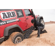 Man pushing tire on jeep displaying ARB Tred Pro Black/Black.