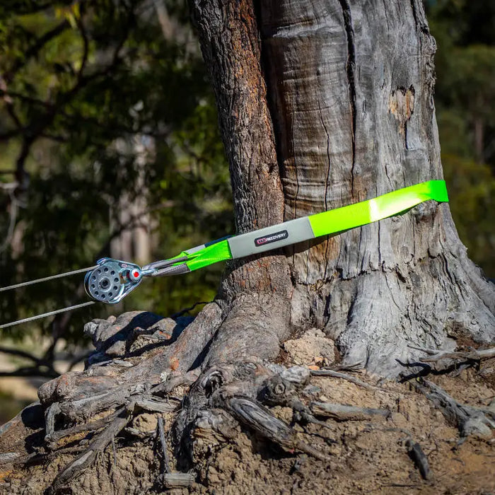 ARB Tree Protector 10Ft: Person using strap wrap to tie tree - recovery straps.