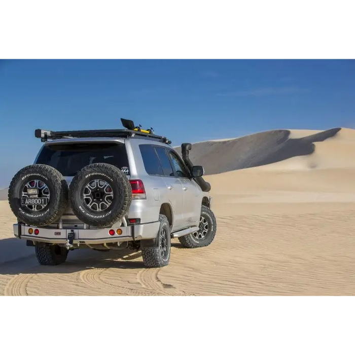 White truck with spare tire cover, arb w/carrier arb rstb lhs blk.