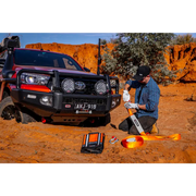 Man working on vehicle in desert - ARB Weekender Recovery Kit