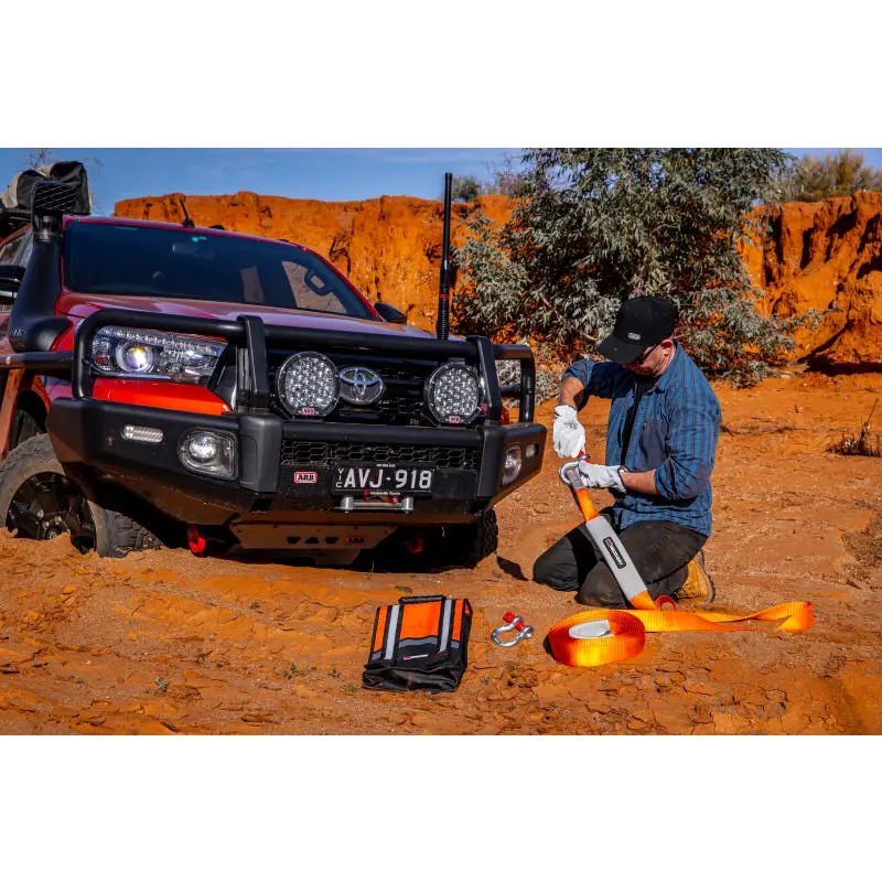Man working on vehicle in desert - ARB Weekender Recovery Kit