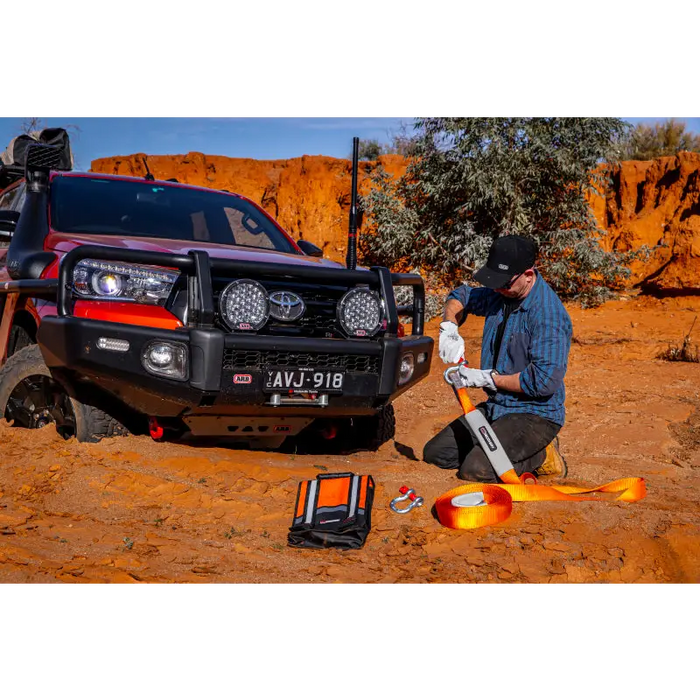 Man working on vehicle in desert - ARB Weekender Recovery Kit