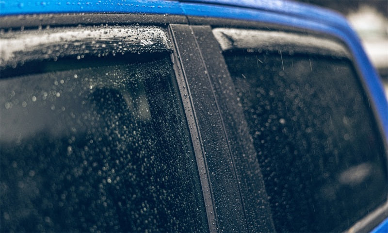 Blue car with rain on windshield featuring avs 01-04 toyota hilux double cab ventvisor in-channel front & rear window deflectors 4pc