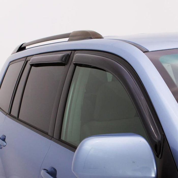 Blue car with black roof rack featuring avs 03-09 toyota 4runner ventvisor outside mount window deflectors - smoke