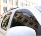 Toyota tacoma access cab window deflector with building reflection