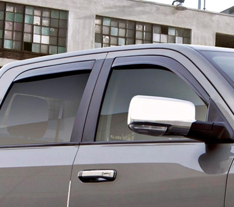 Gray car parked in front of a building with avs toyota tacoma access cab ventvisor low profile deflectors