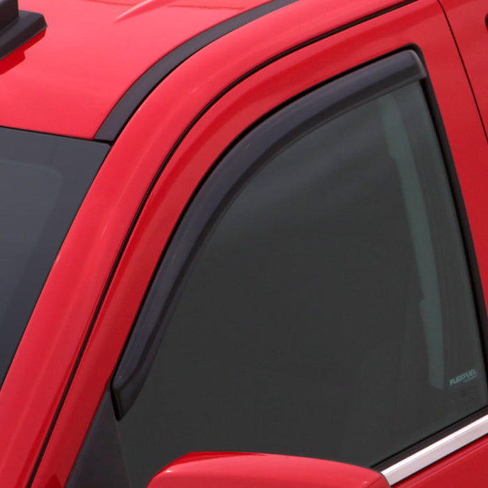 Red car with black roof featuring avs toyota tacoma standard cab ventvisor in-channel window deflectors for fresh air flow