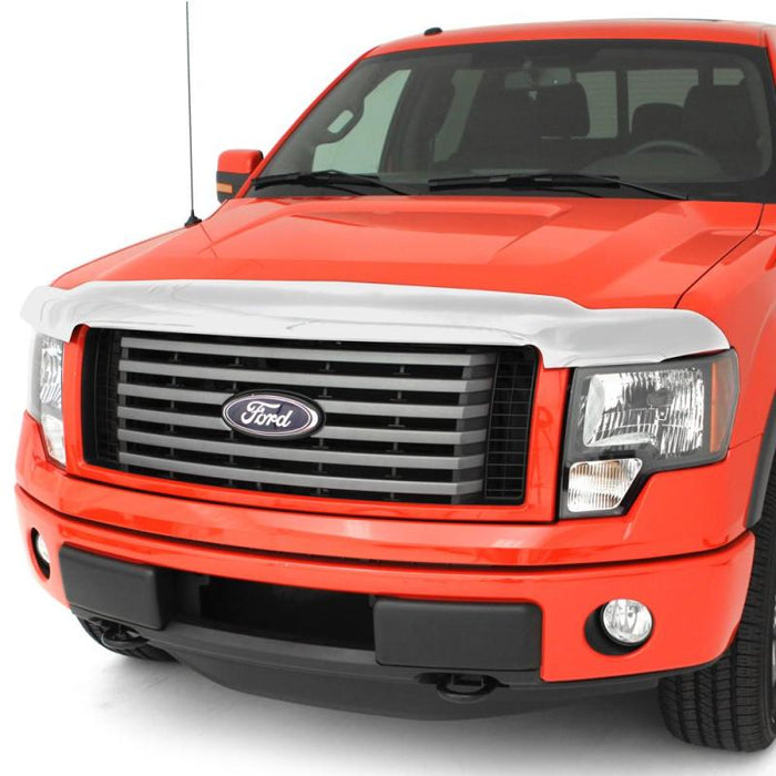 Red truck with white background featuring avs chrome hood shield for toyota 4runner