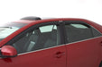 Red car parked in a lot with avs original ventvisor window deflectors on