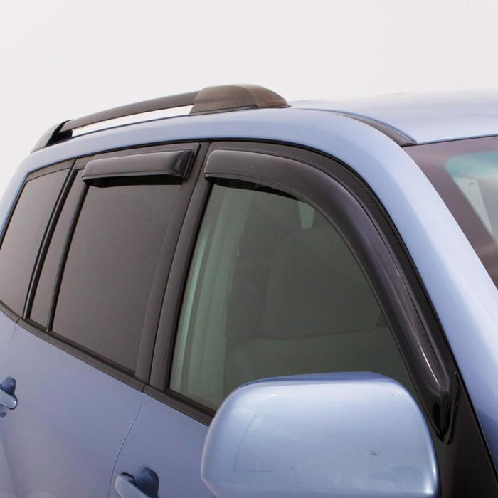 Blue car with black roof rack showcasing avs 07-18 jeep patriot ventvisor outside mount window deflectors - smoke