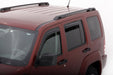 Red van parked on white surface with avs jeep liberty window deflectors