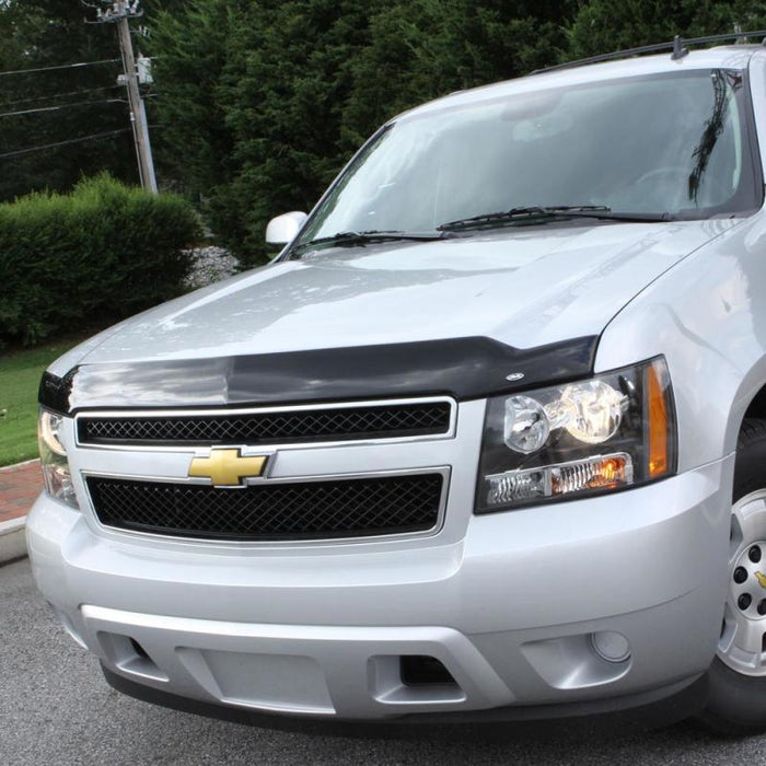 Silver chevrolet suv parked in parking lot with avs aeroskin hood shield - smoke