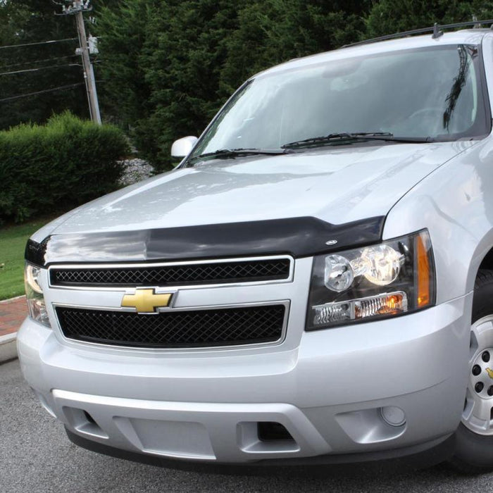 Silver chevrolet suv parked in lot with avs aeroskin hood shield - smoke