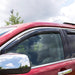 Red car with black roof rack featuring avs 10-18 toyota 4runner ventvisor in-channel front & rear window deflectors for fresh air