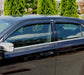 Black car parked with avs original ventvisor window deflectors in parking lot - providing fresh air flow